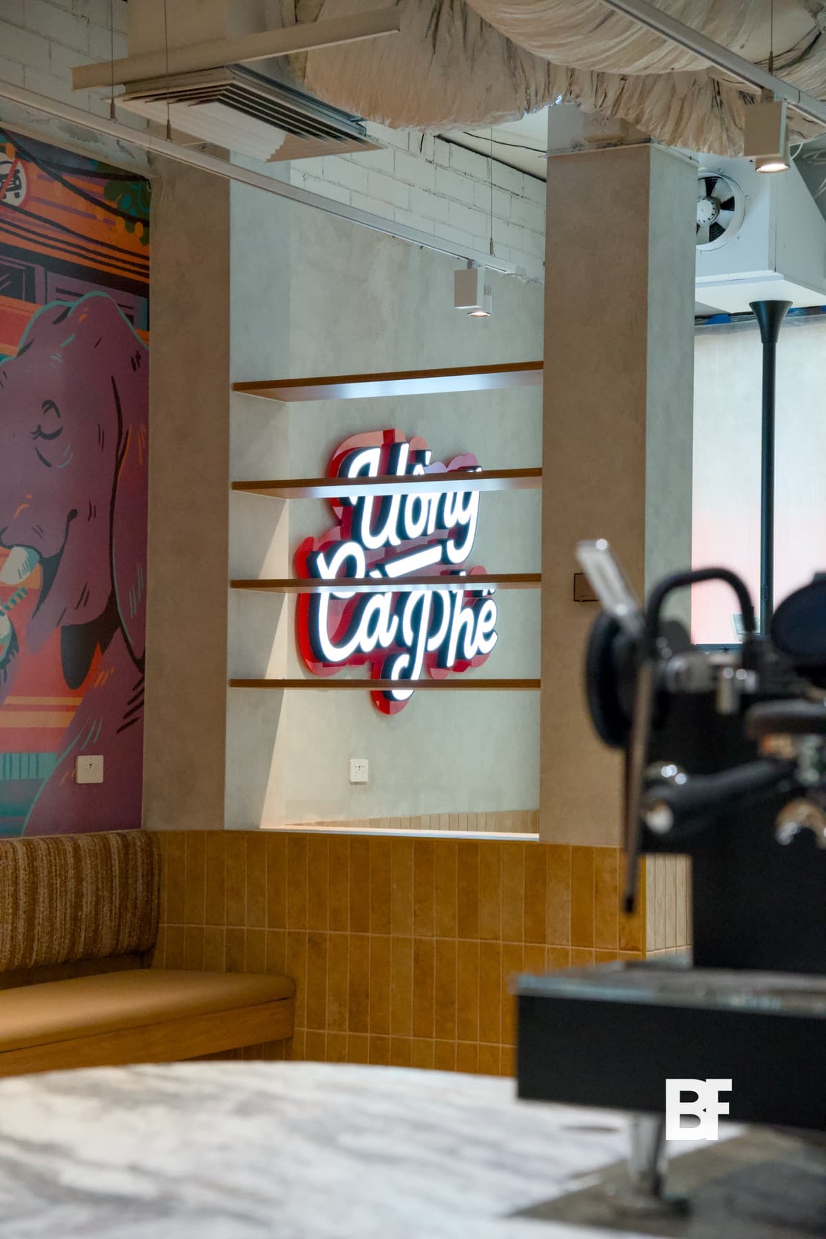 Cafe counter and Yugo Coffee neon sign photographed by BASEFORM