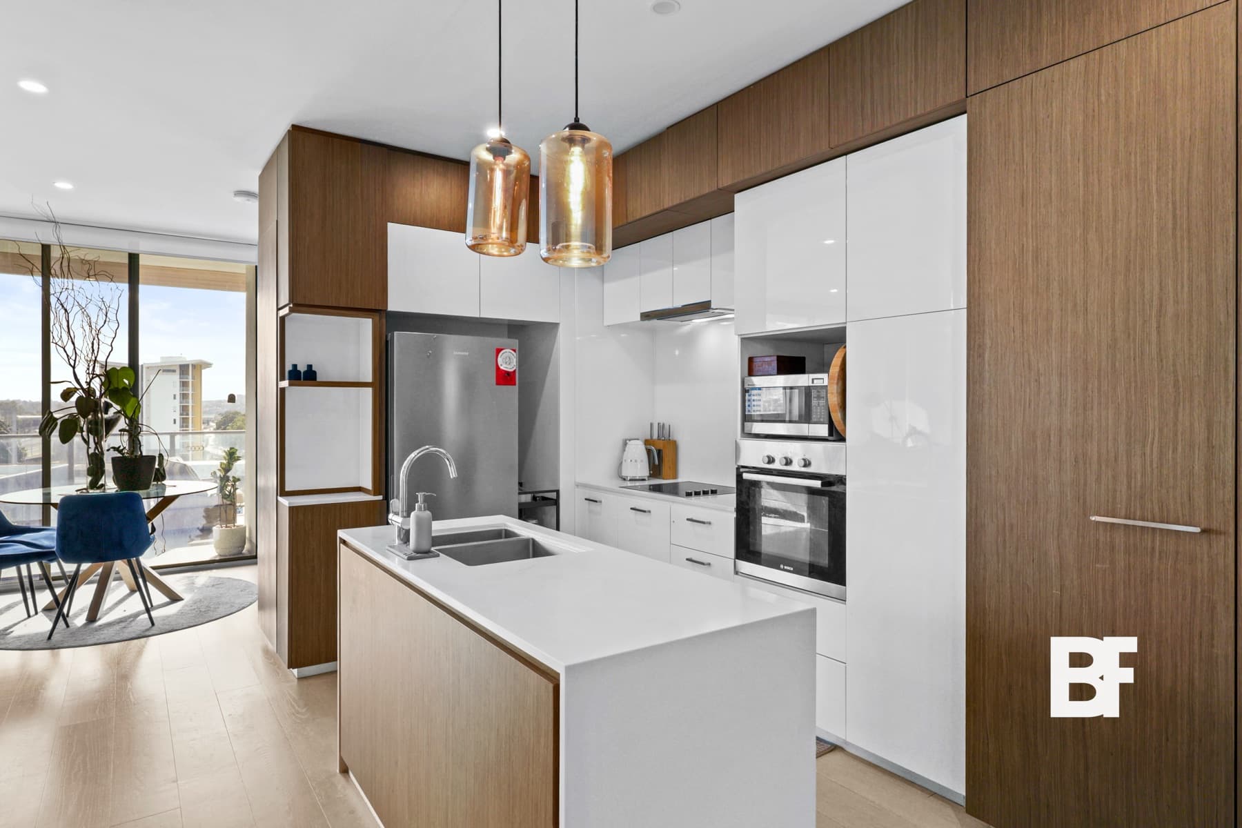 Modern apartment kitchen with timber cabinetry photographed by BASEFORM